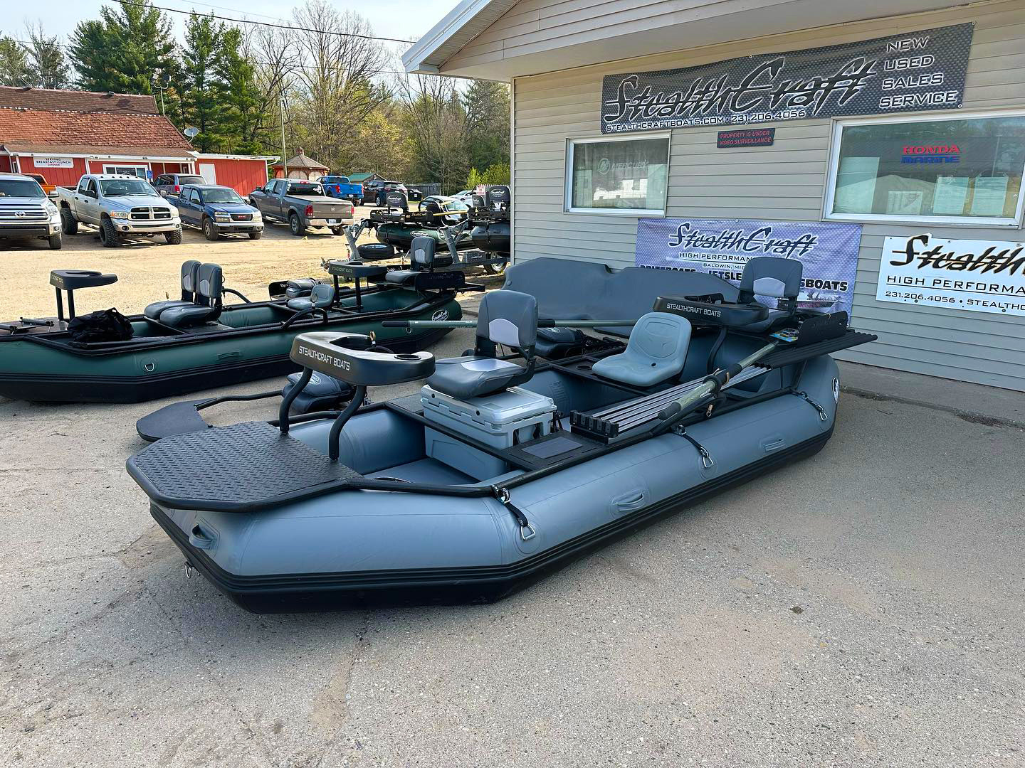 Gray Stealthcraft Hooligan Raft XXL showing the bow platform, seats, oars, and casting braces at the manufacturer’s yard